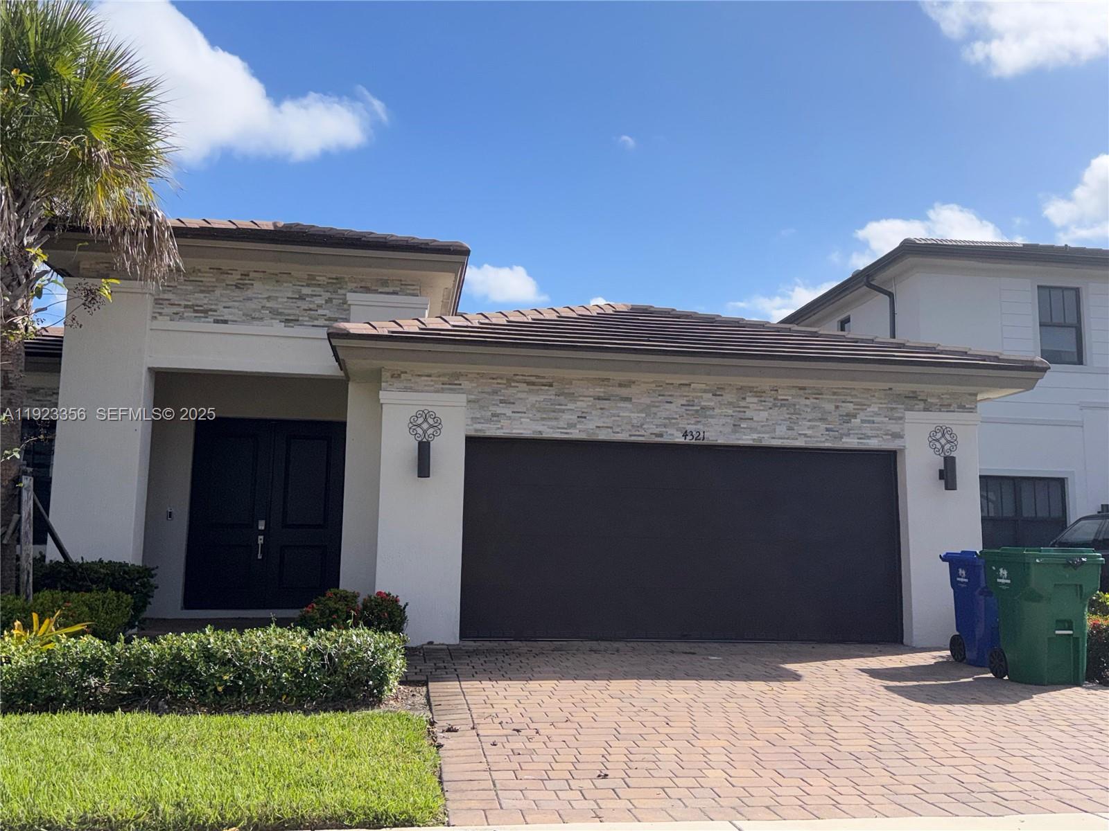 4321 Southwest 173rd Avenue Miramar, FL 33029 - Photo 3 of 28 a front view of a house with a garden