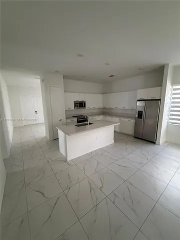 a kitchen with cabinets and white appliances
