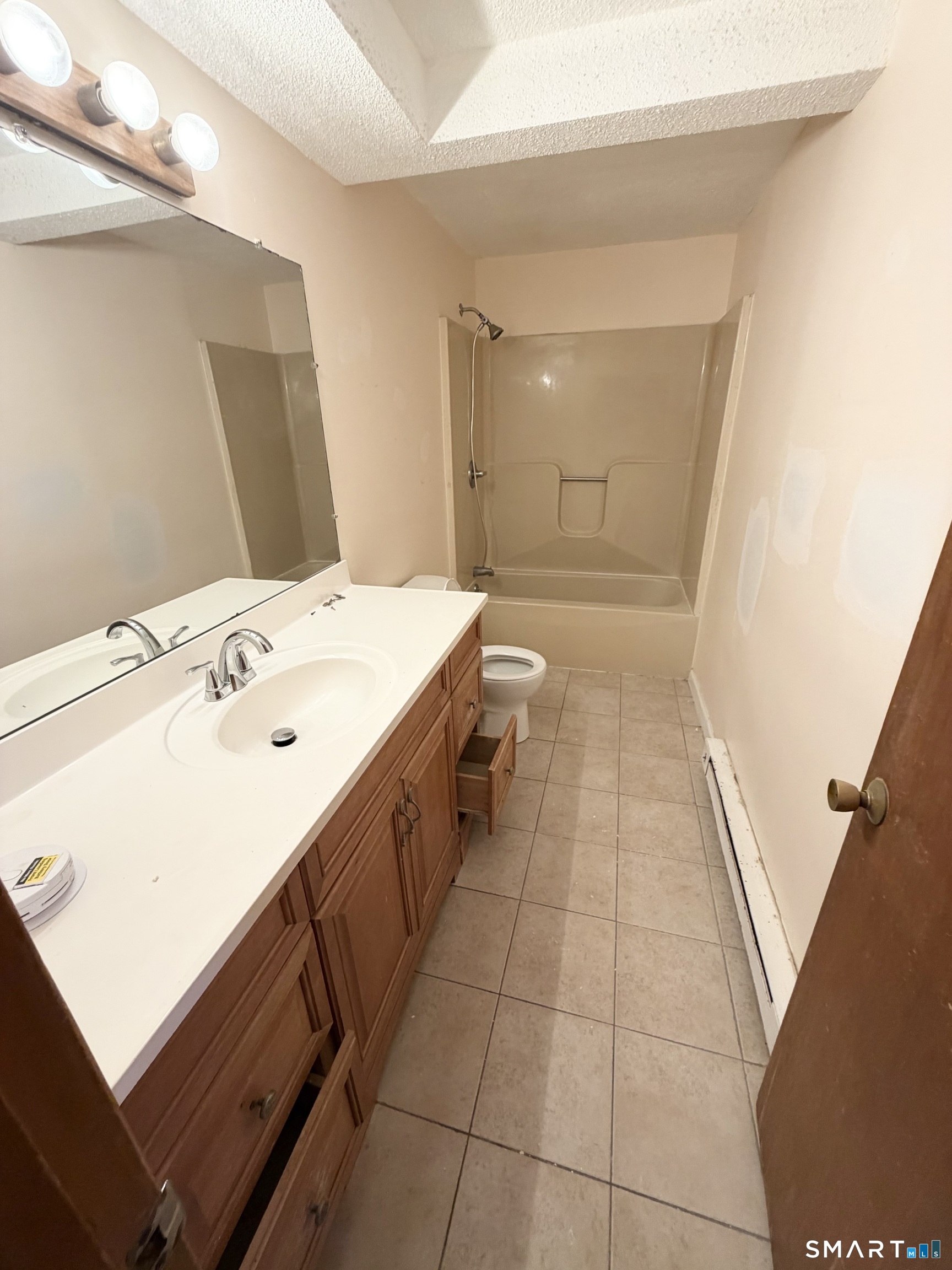 33 River Street Windsor, CT 06095 - Photo 5 of 11 a bathroom with a sink a mirror and a shower