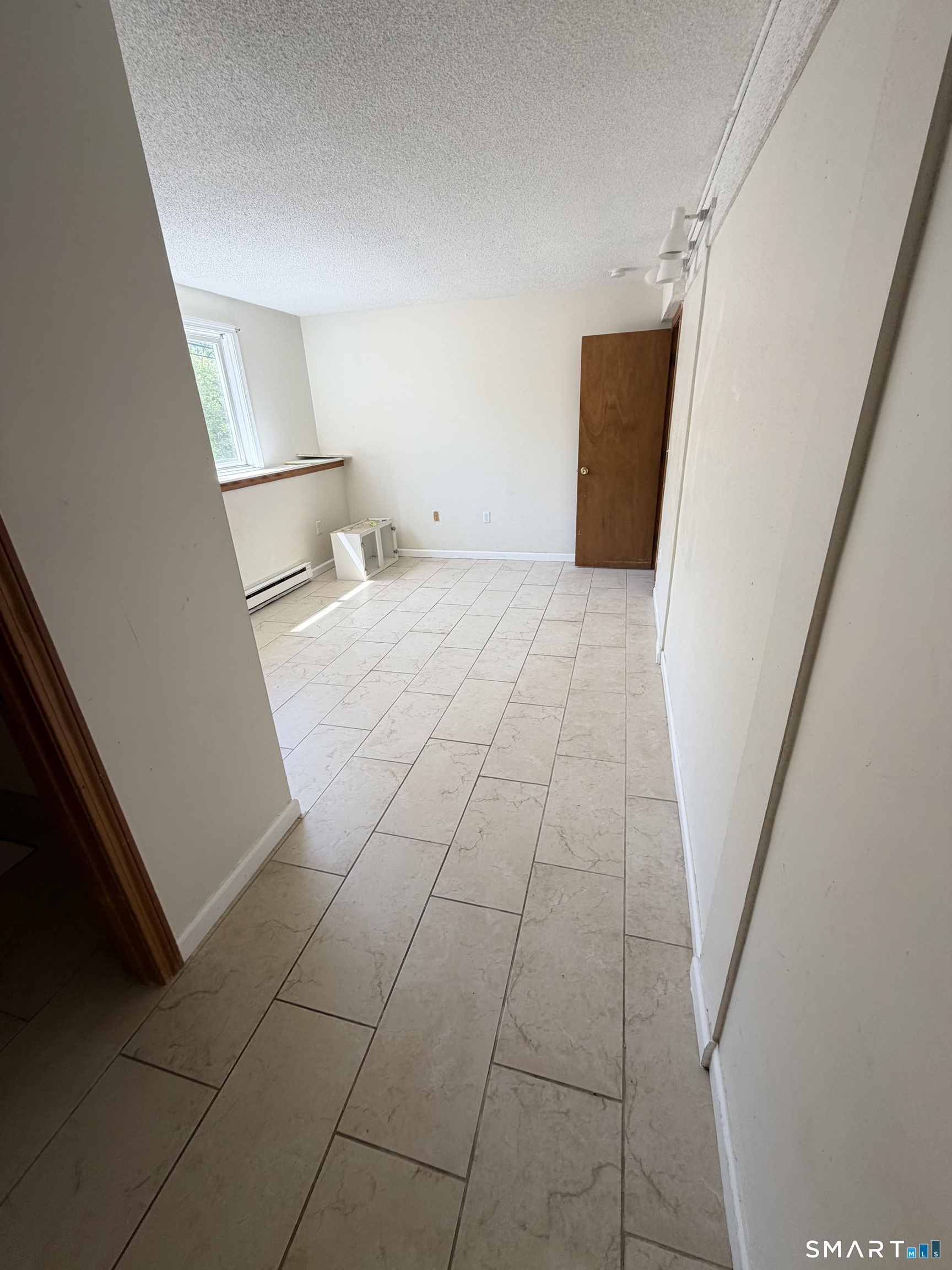 33 River Street Windsor, CT 06095 - Photo 8 of 11 a view of an empty room with wooden floor and a window