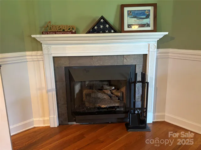 a living room with a fireplace and a wooden floor
