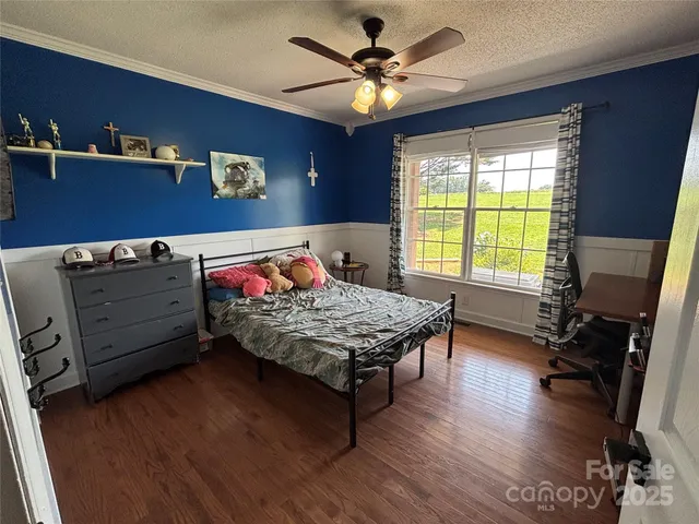 a living room with hard wood floors and a window
