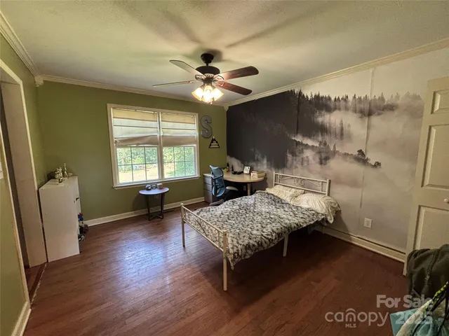 a bedroom with furniture and a window