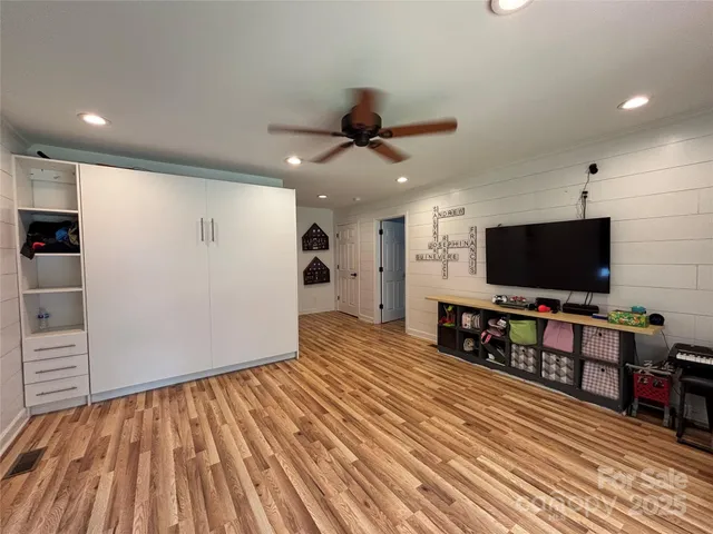 a view of a livingroom with furniture and a flat screen tv