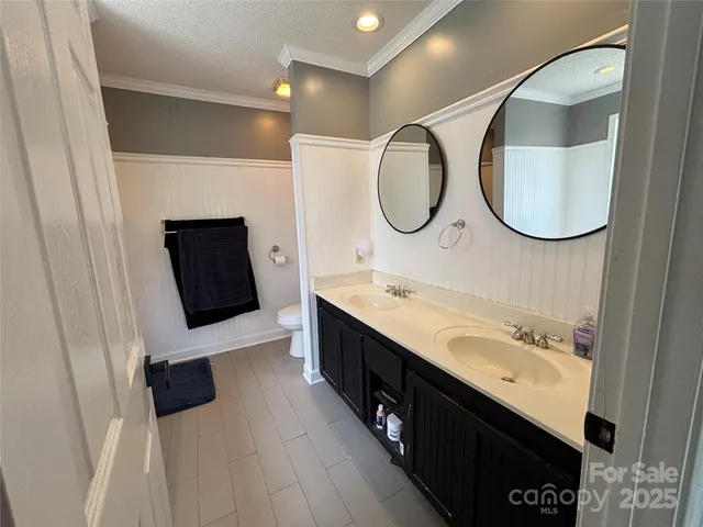 a bathroom with a double vanity sink and a mirror