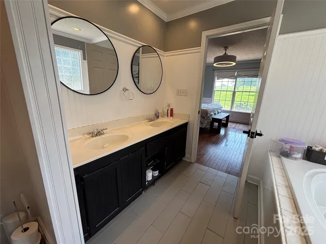 a bathroom with a double vanity sink mirror and a toilet