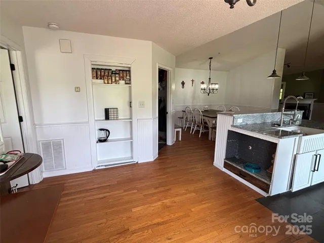 a view of kitchen with furniture and wooden floor