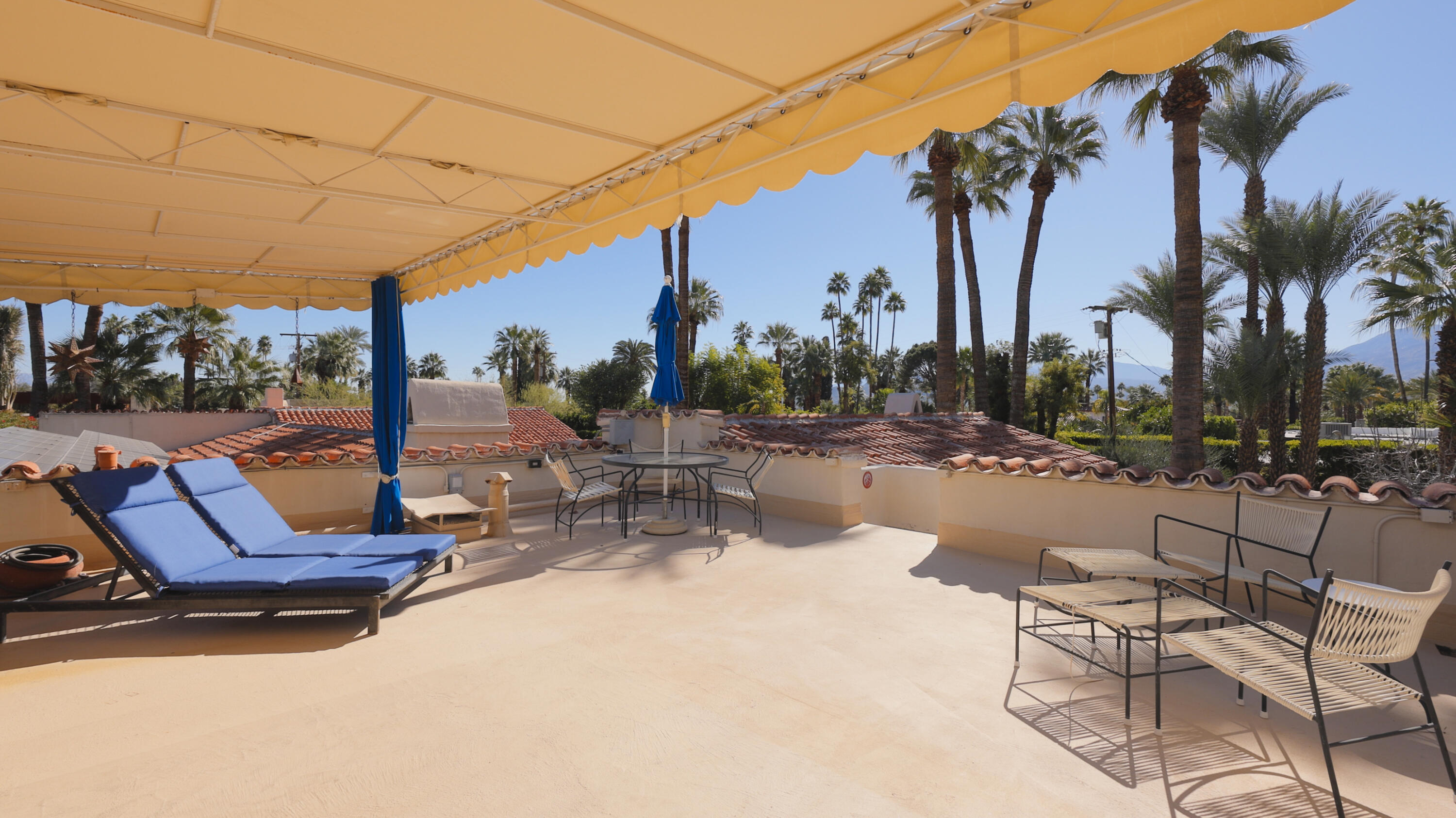 1050 North Cahuilla Road Palm Springs, CA 92262 - Photo 19 of 32 a view of a patio with a table and chairs