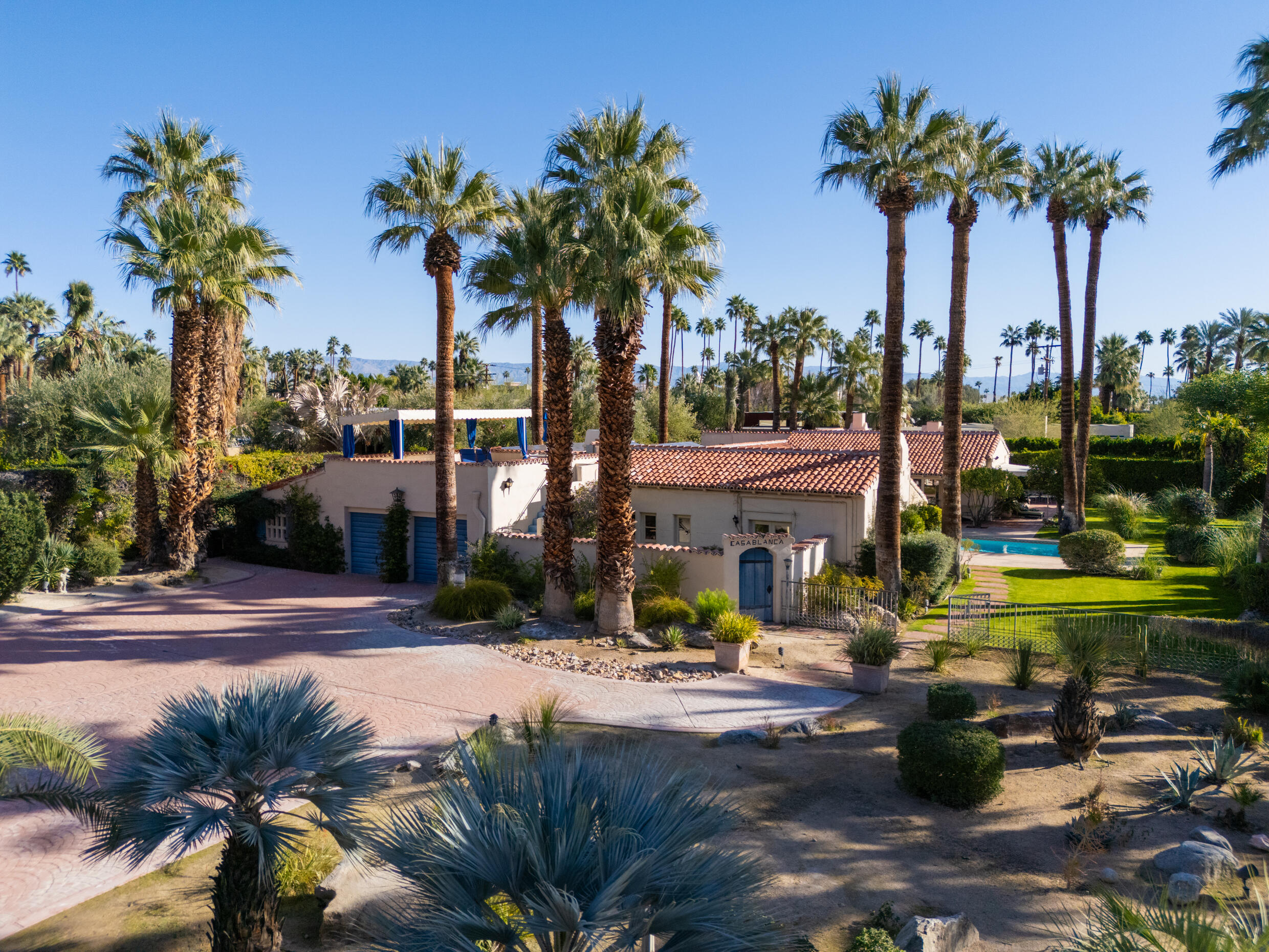 1050 North Cahuilla Road Palm Springs, CA 92262 - Photo 5 of 32 a view of swimming pool with a table and chairs