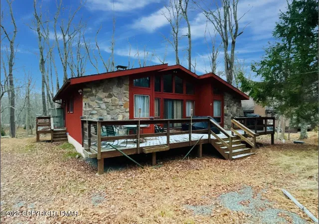 a view of a yard with wooden fence