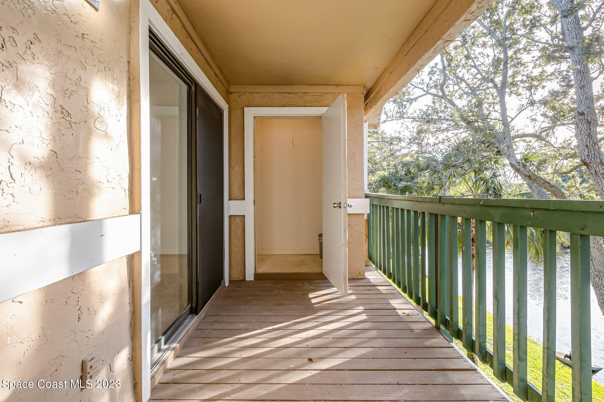 7667 North Wickham Road, Unit 218 Melbourne, FL 32940 - Photo 12 of 35 a view of a balcony with wooden floor
