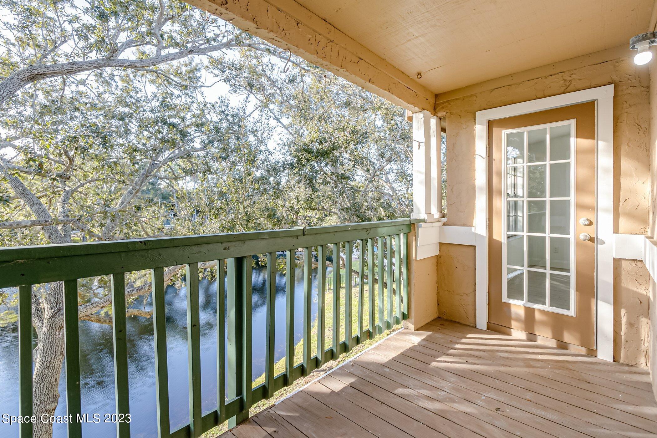 7667 North Wickham Road, Unit 218 Melbourne, FL 32940 - Photo 13 of 35 a view of a balcony with wooden floor
