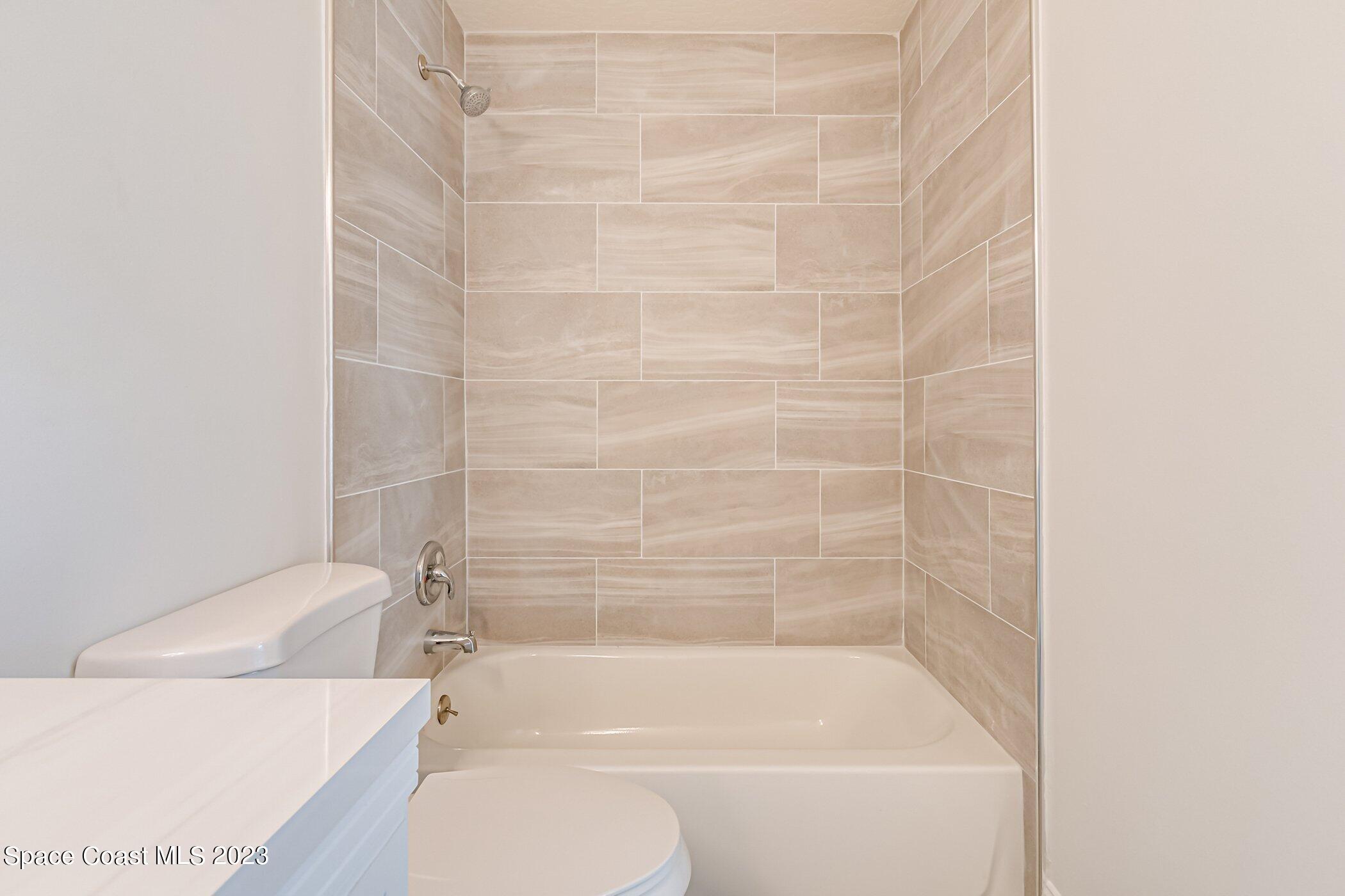 7667 North Wickham Road, Unit 218 Melbourne, FL 32940 - Photo 16 of 35 a bathroom with a bathtub and a toilet