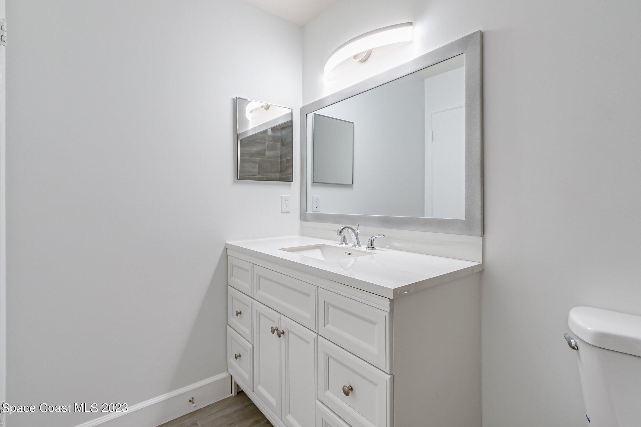 7667 North Wickham Road, Unit 218 Melbourne, FL 32940 - Photo 17 of 35 a bathroom with a sink and a mirror