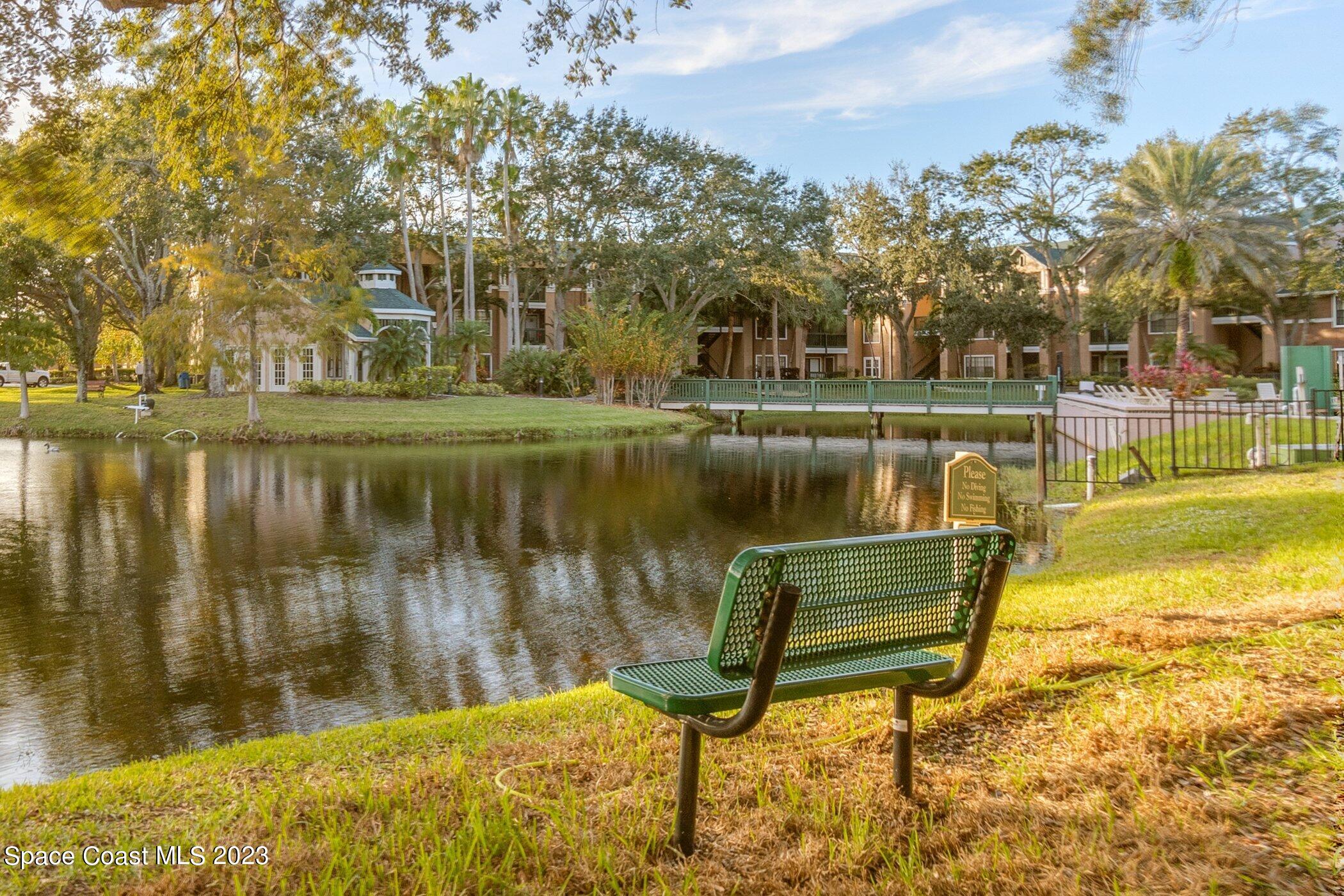 7667 North Wickham Road, Unit 218 Melbourne, FL 32940 - Photo 22 of 35 a swimming pool with outdoor seating and yard