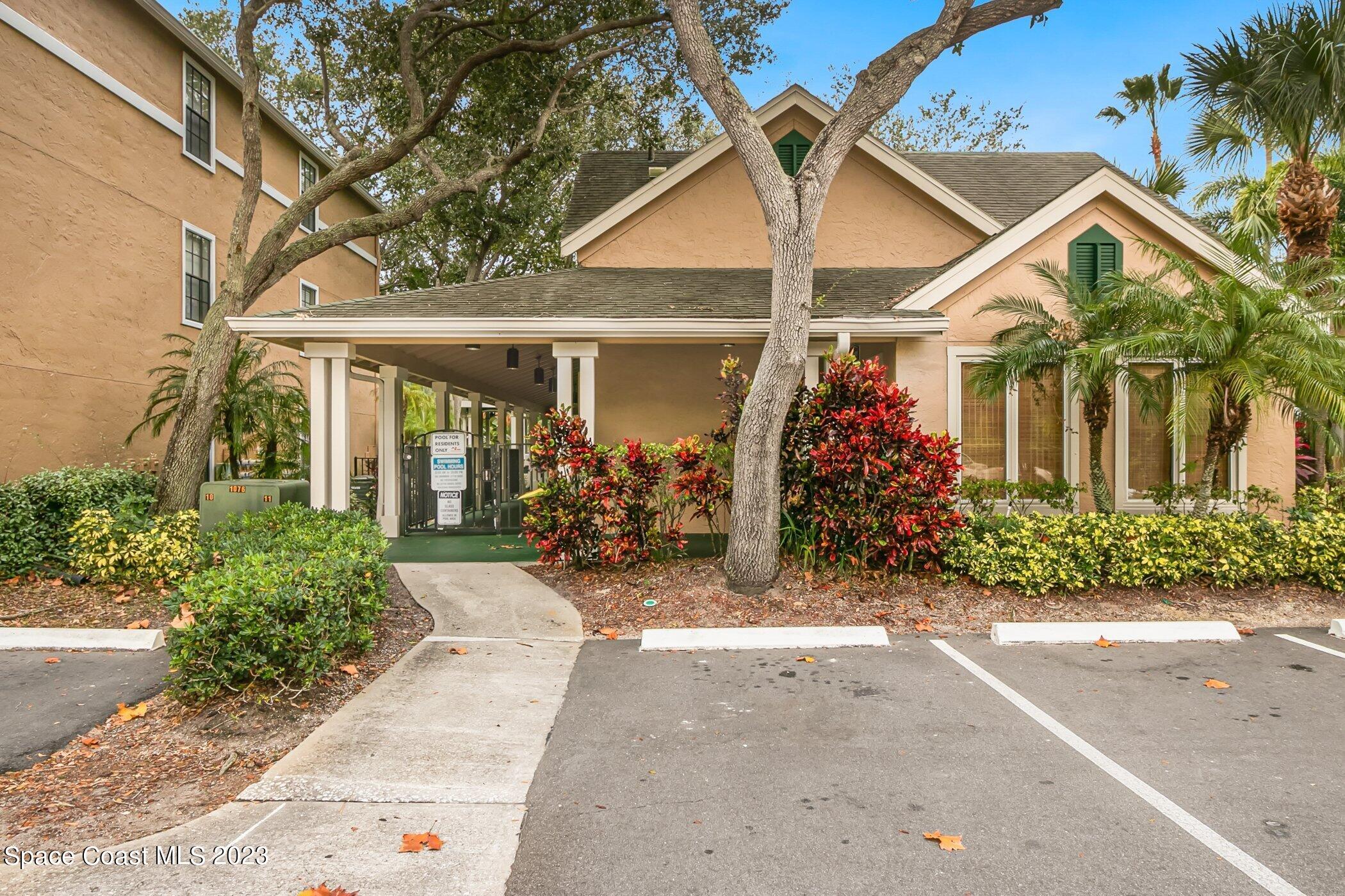 7667 North Wickham Road, Unit 218 Melbourne, FL 32940 - Photo 26 of 35 front view of a house with a small yard