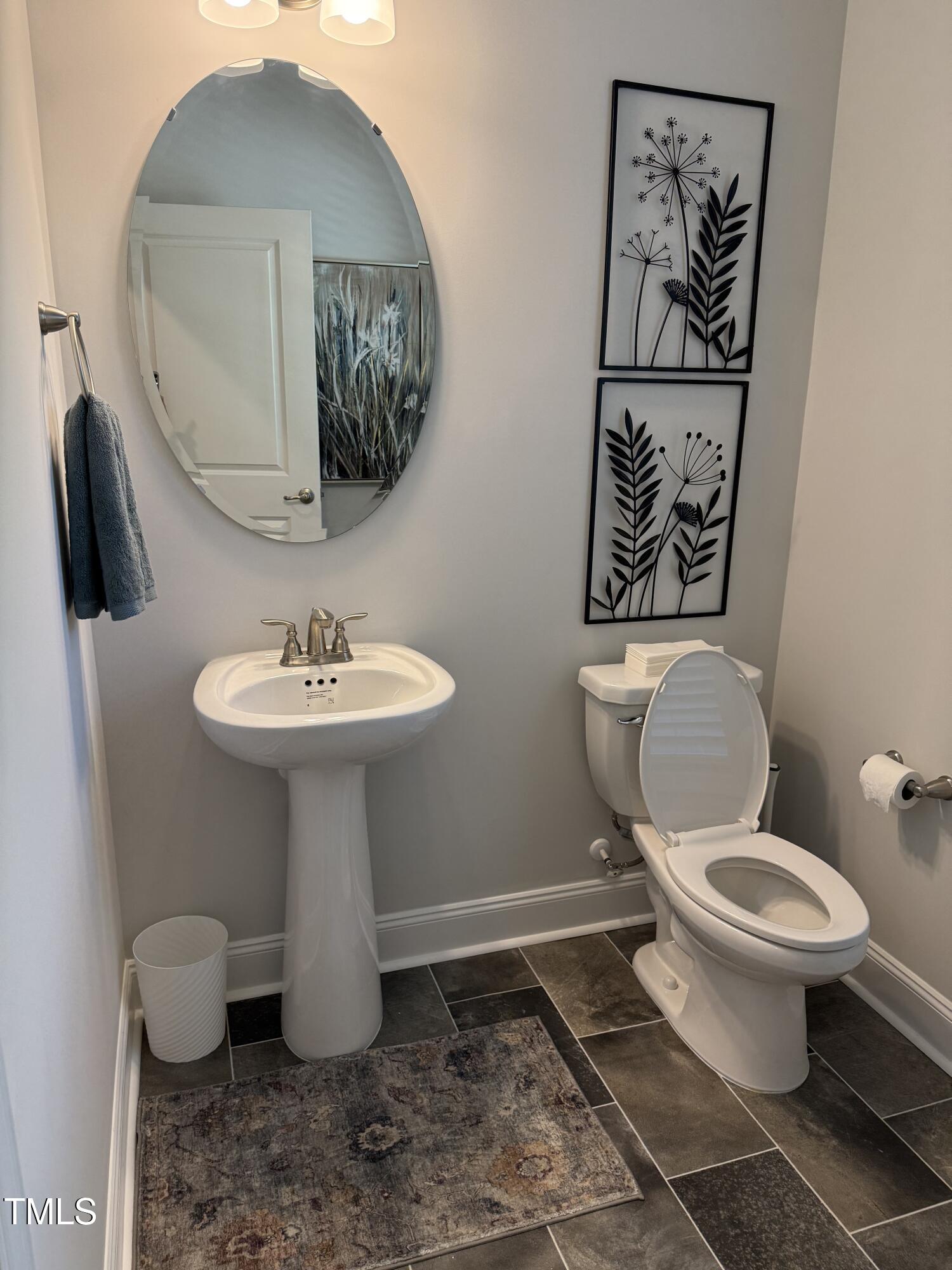 30 Lemon Drop Lane Louisburg, NC 27549 - Photo 5 of 21 a bathroom with a toilet sink and mirror