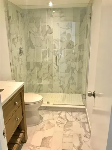 a bathroom with a toilet and shower