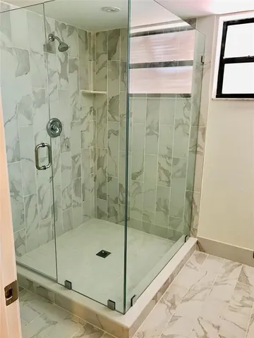 a bathroom with a glass shower door