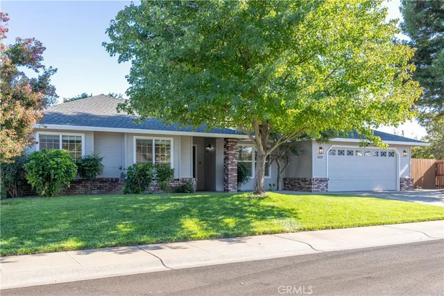 a view of a house with a yard and plants