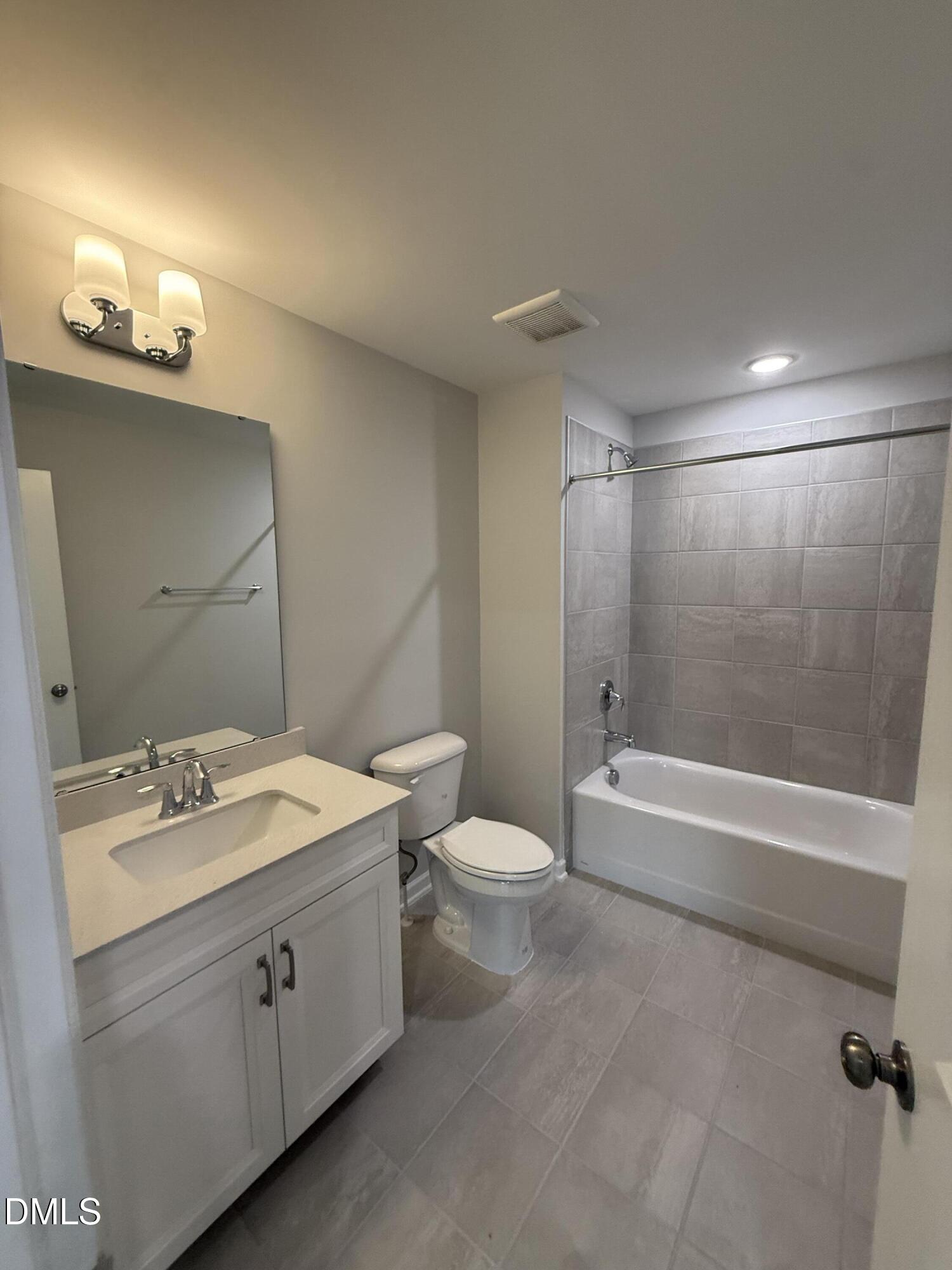 2429 Picual Way Apex, NC 27502 - Photo 14 of 21 a bathroom with a double vanity sink toilet and shower