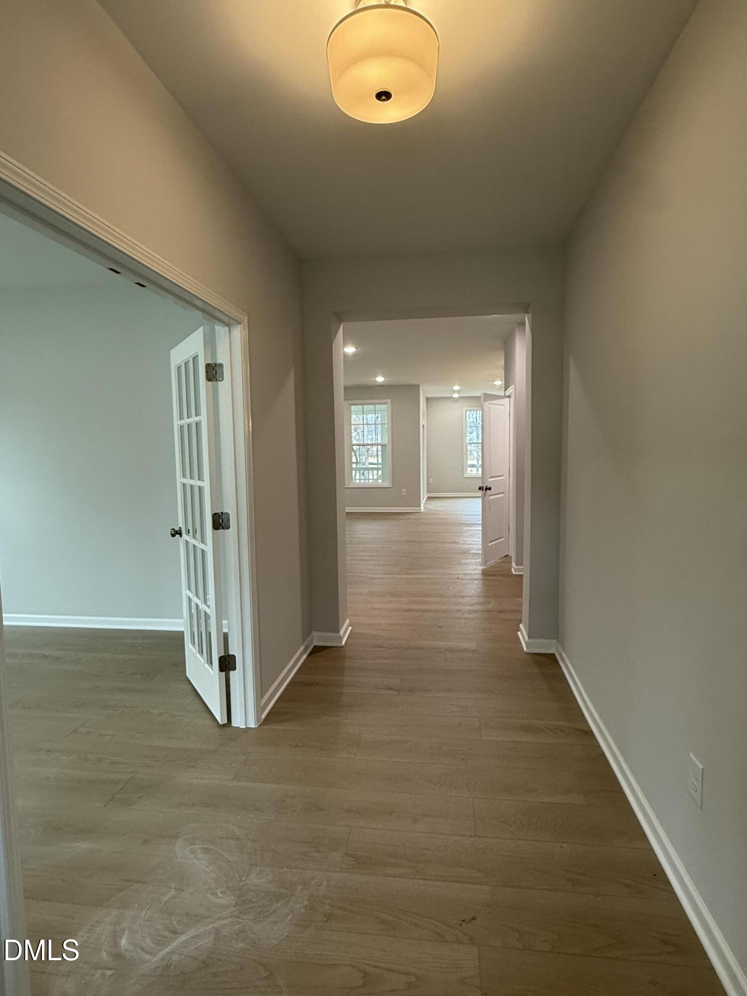 2429 Picual Way Apex, NC 27502 - Photo 2 of 21 an empty room with wooden floor and windows