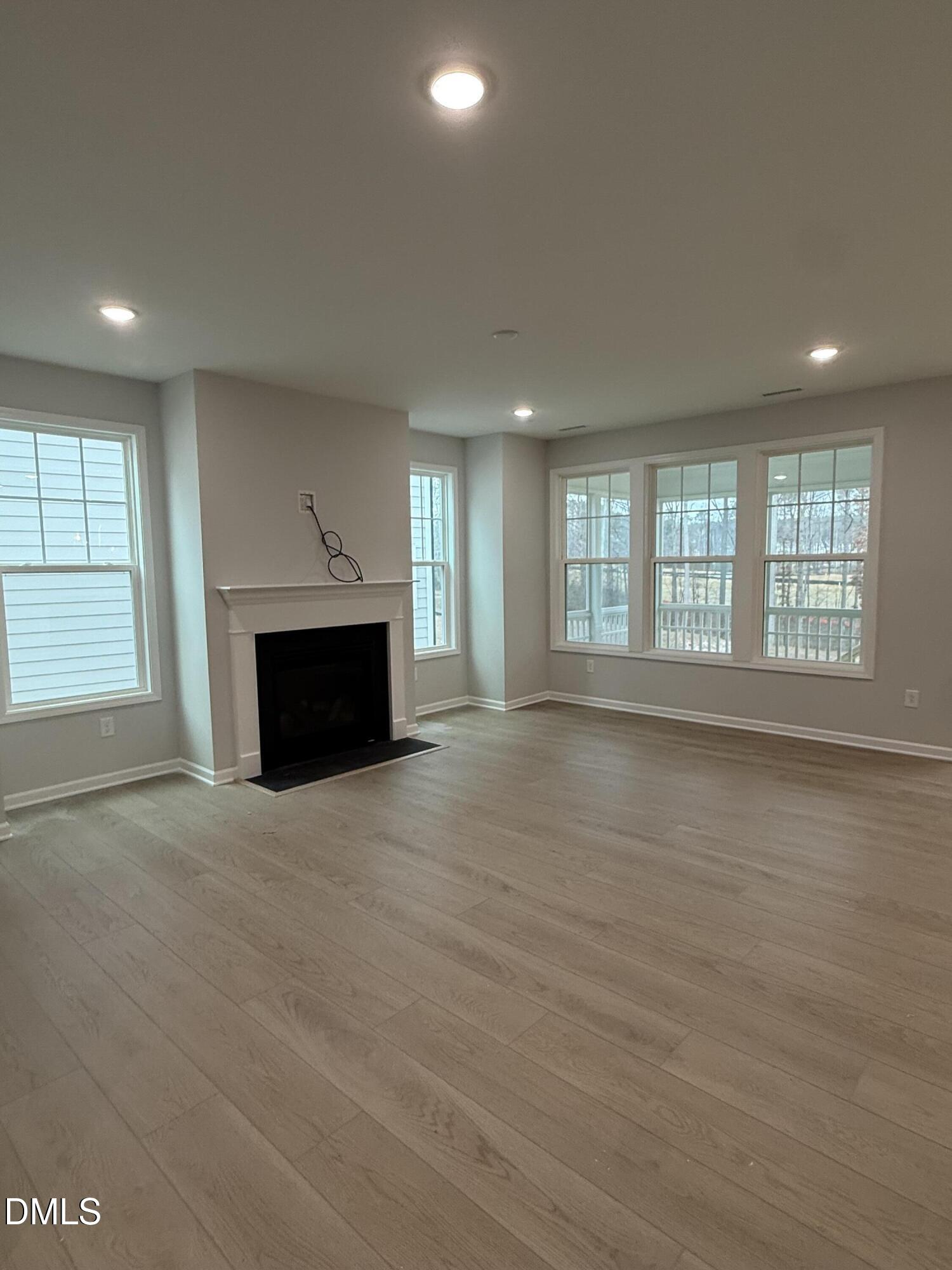 2429 Picual Way Apex, NC 27502 - Photo 3 of 21 an empty room with windows and fireplace