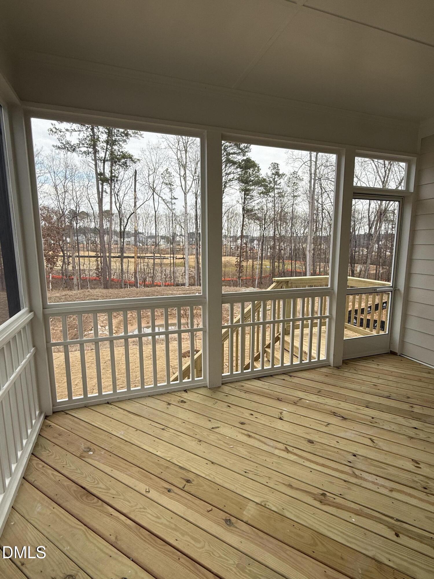 2429 Picual Way Apex, NC 27502 - Photo 5 of 21 a view of a room with wooden floor and a floor to ceiling window