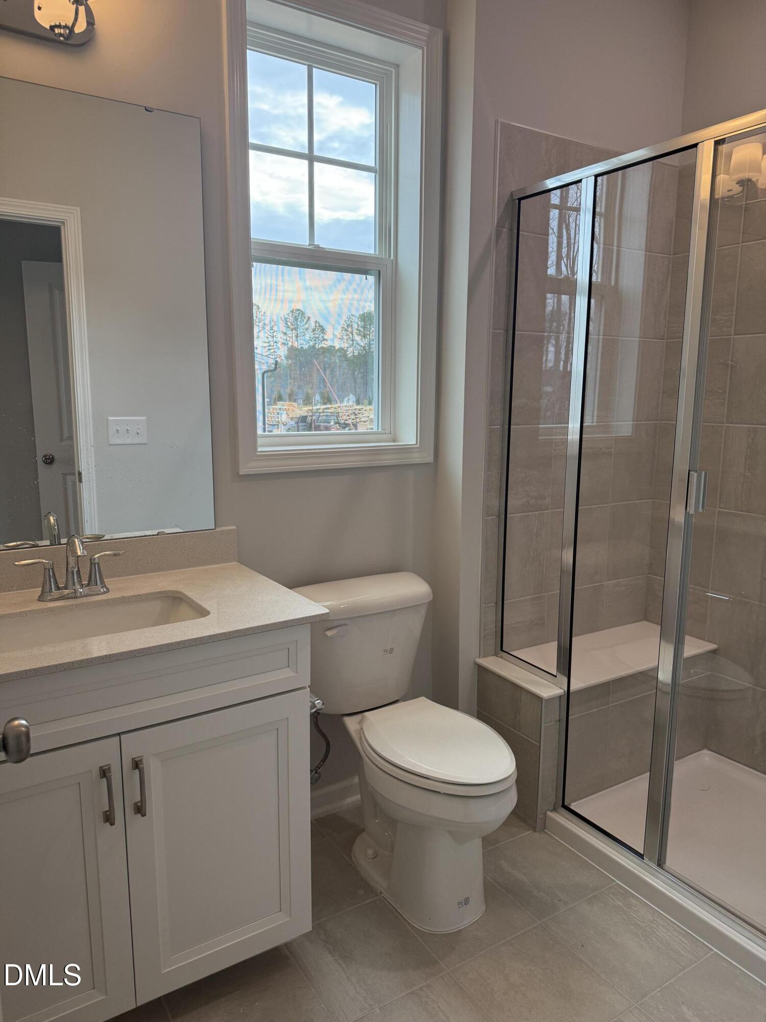 2429 Picual Way Apex, NC 27502 - Photo 6 of 21 a bathroom with a toilet a sink and a shower