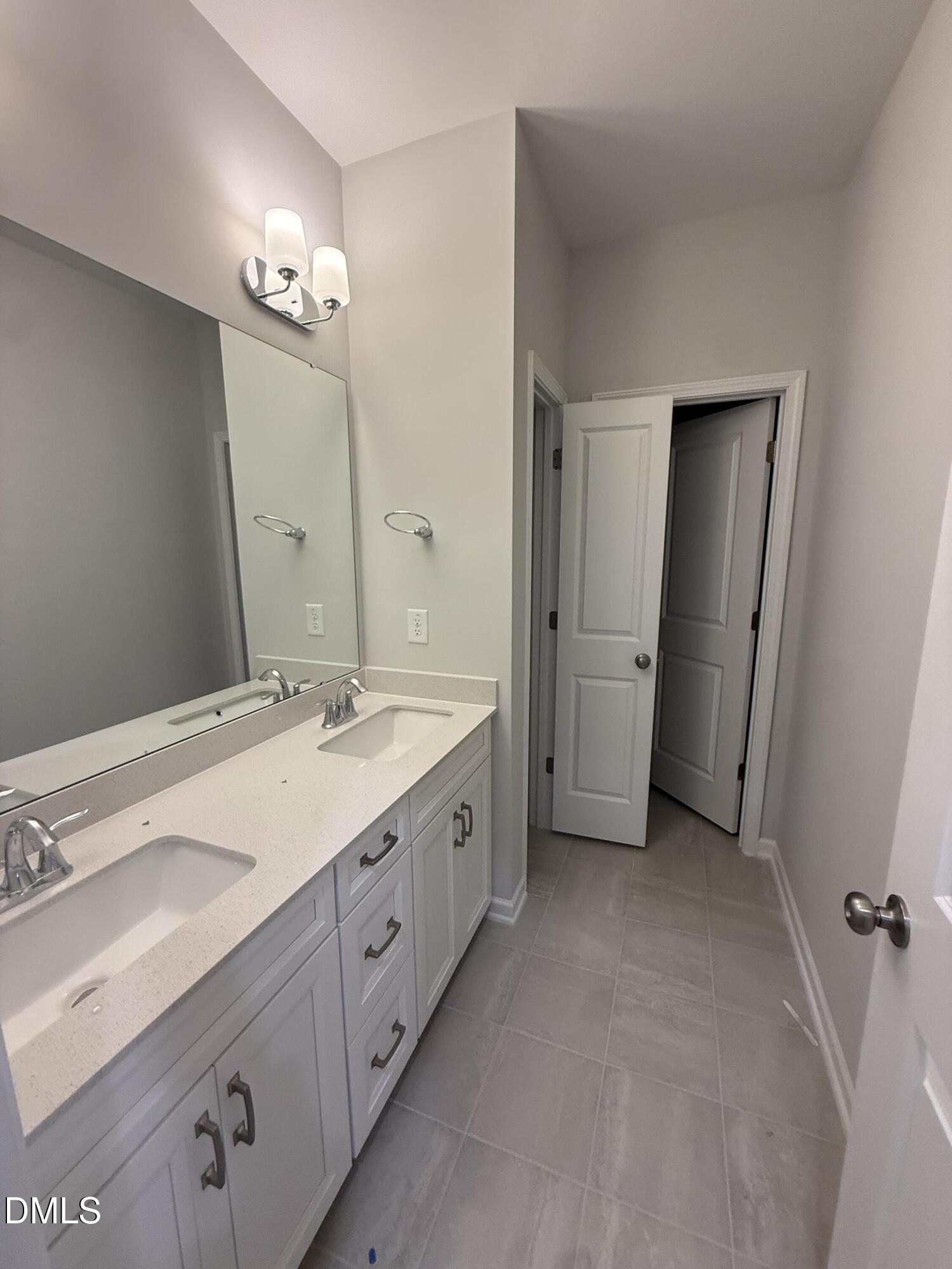 2429 Picual Way Apex, NC 27502 - Photo 10 of 21 a spacious bathroom with double vanity sink a mirror and a shower