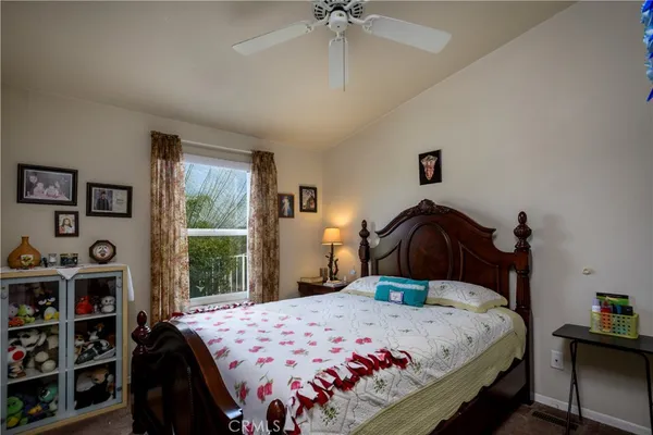 a living room with furniture a flat screen tv and a window