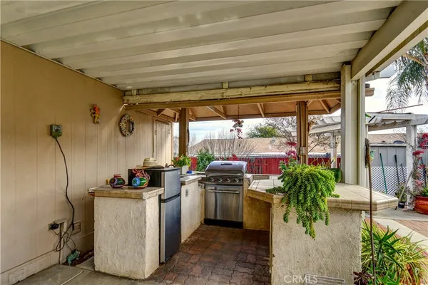 a view of a patio with chairs and potted plants