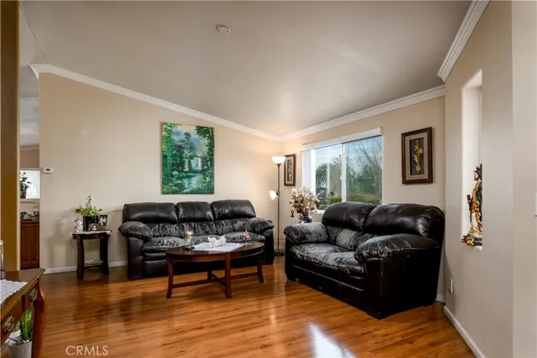 a kitchen with a dining table chairs and refrigerator