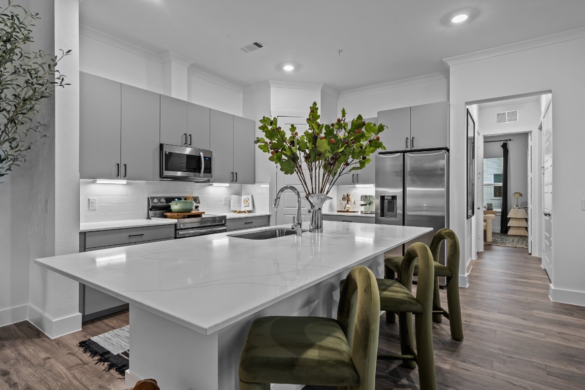 a kitchen with kitchen island a table and chairs in it