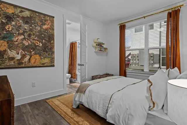 a bedroom with a bed and a painting on the wall