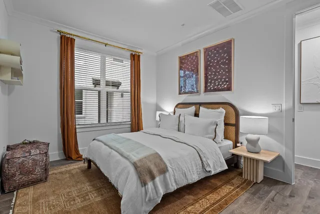 a bedroom with a bed and wooden floor