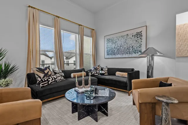 a living room with furniture and a large window with rug
