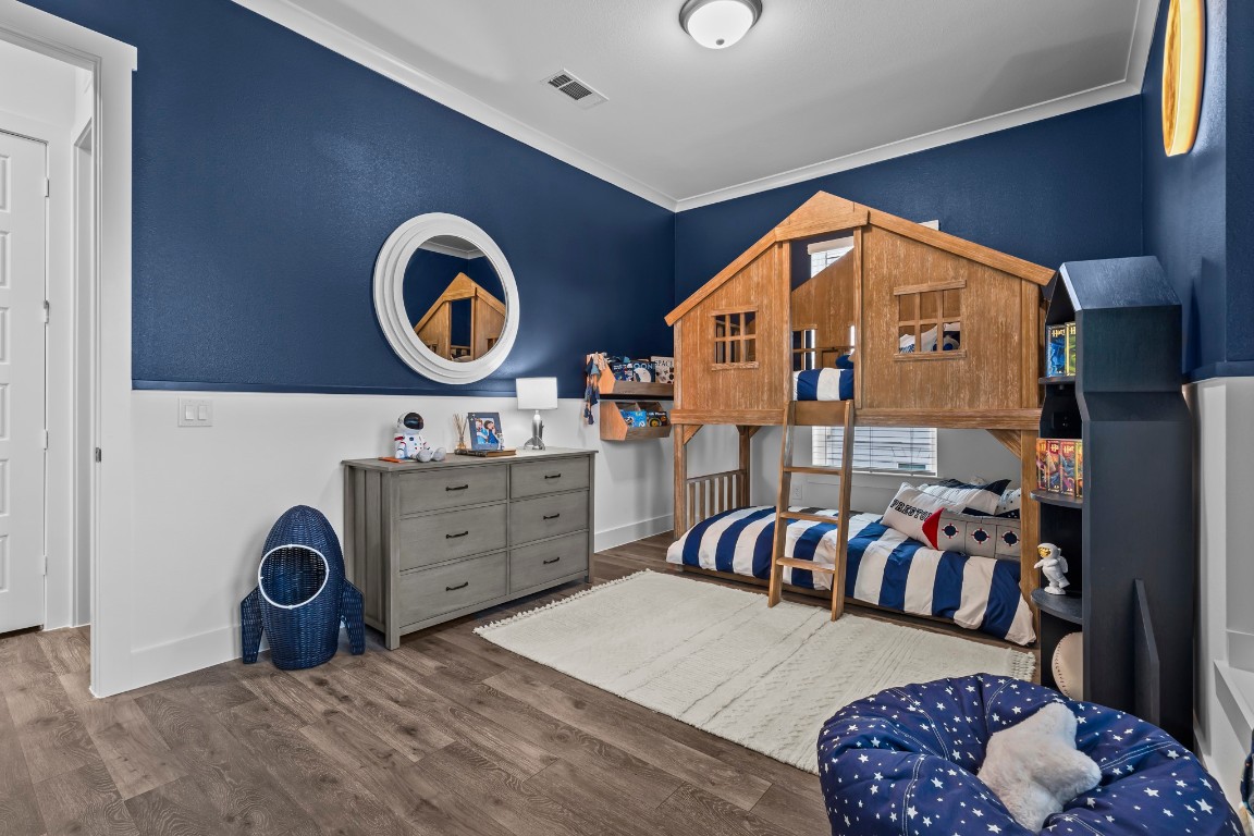 1664 Hillside Terrace, Unit 2117 Buda, TX 78610 - Photo 33 of 33 a bedroom with a bed and a lamp on dresser