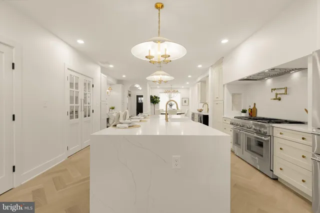 a kitchen with stainless steel appliances granite countertop a sink and cabinets with wooden floor