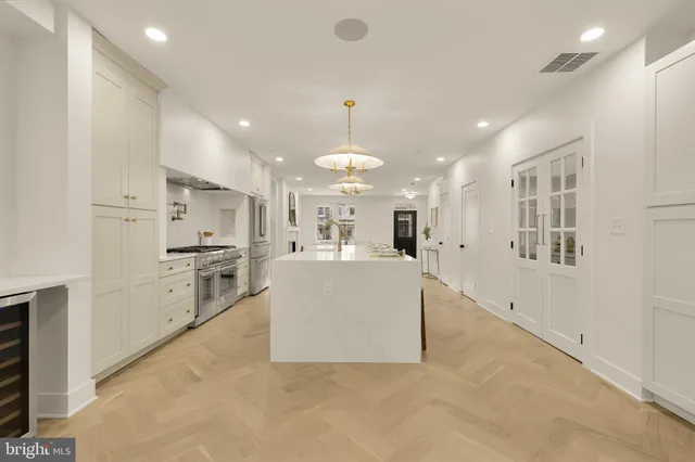 a kitchen with stainless steel appliances granite countertop a stove and a refrigerator