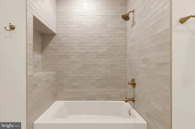 a bedroom with a bed and lamps potted plants next to a large window