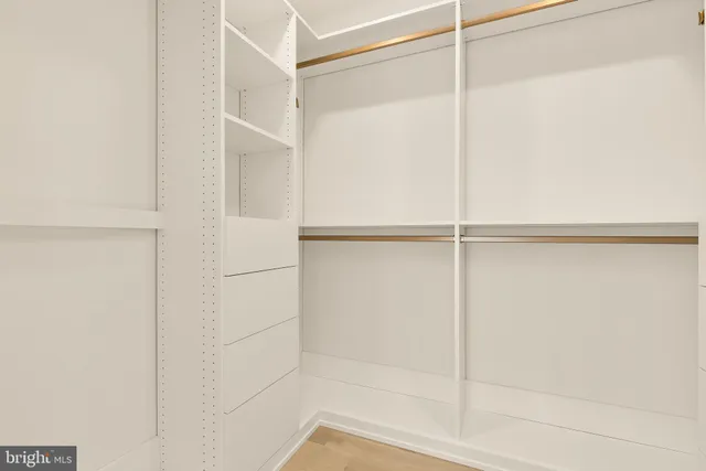 a bathroom with a granite countertop toilet sink and mirror