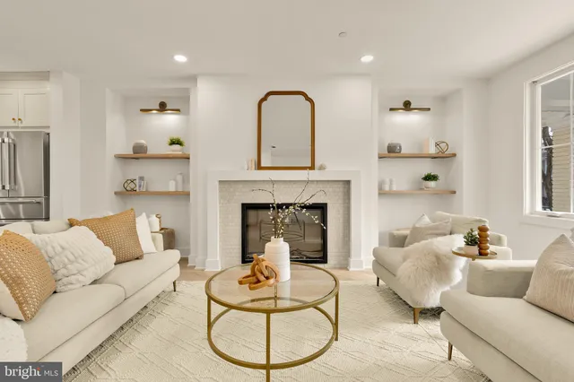 a living room with furniture a fireplace and a chandelier