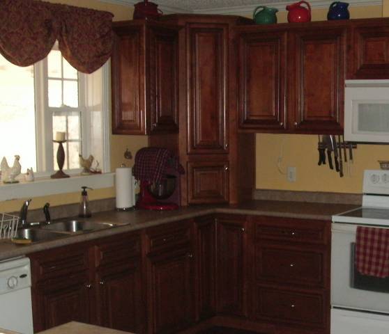 3087 Dry Hill Road Ferrum, VA 24088 - Photo 6 of 11 a kitchen with granite countertop wooden cabinets and a sink