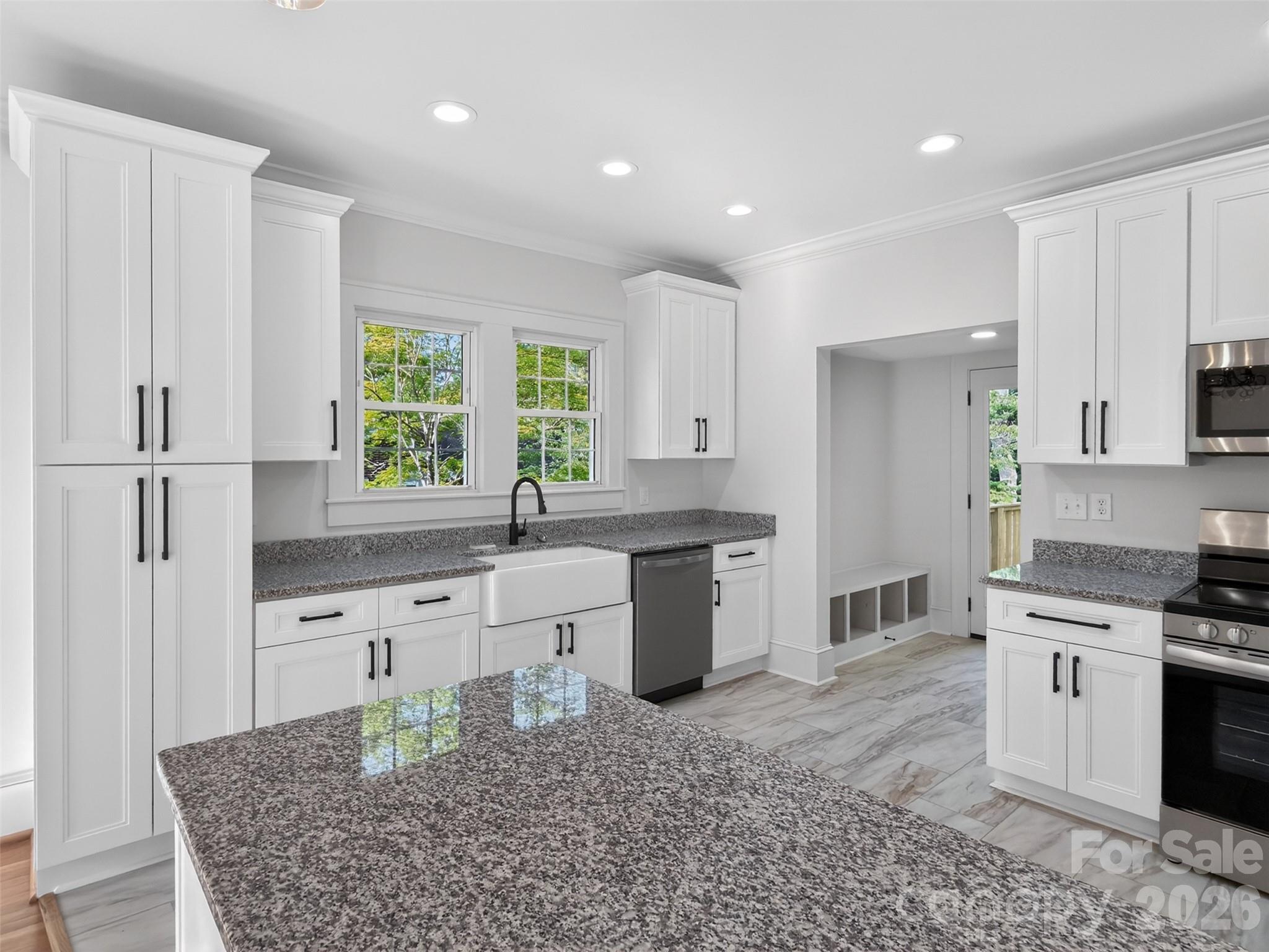 262 Pleasant Street Spindale, NC 28160 - Photo 11 of 37 a kitchen with granite countertop a sink stove and refrigerator