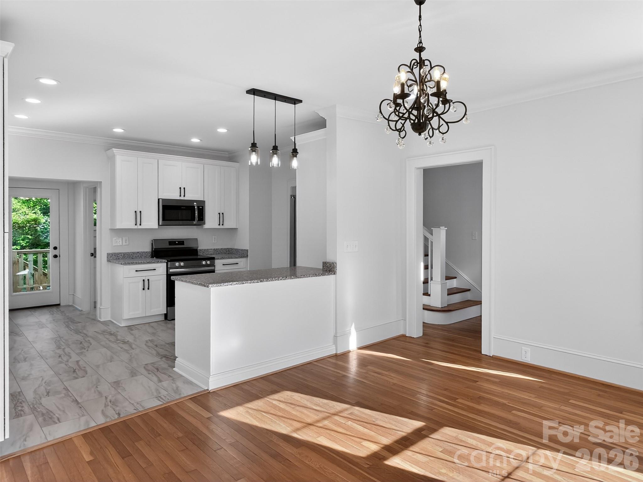 262 Pleasant Street Spindale, NC 28160 - Photo 12 of 37 a open kitchen with white cabinets and stainless steel appliances