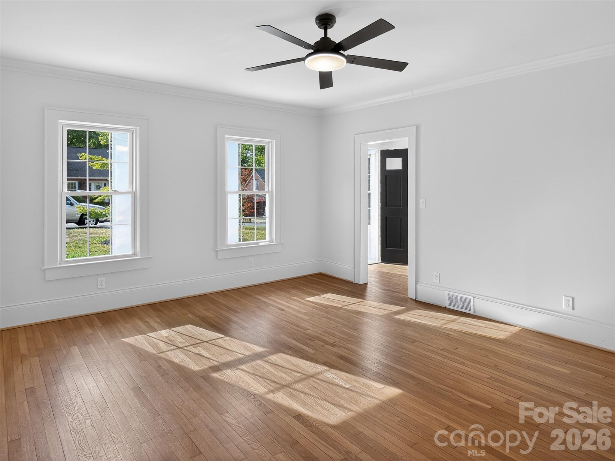 262 Pleasant Street Spindale, NC 28160 - Photo 13 of 37 a view of an empty room with wooden floor and a window