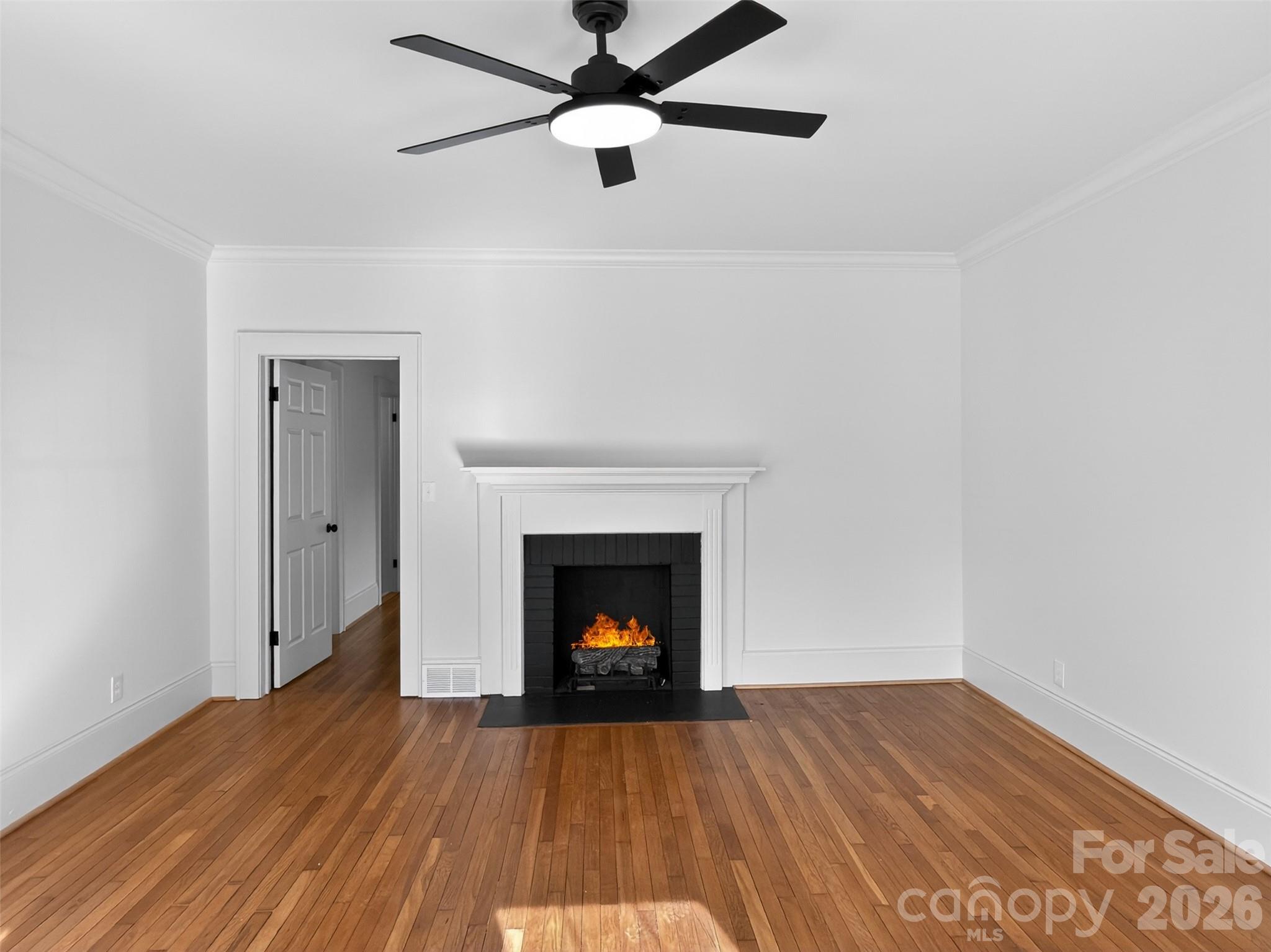 262 Pleasant Street Spindale, NC 28160 - Photo 14 of 37 a view of an empty room with wooden floor fireplace and a window