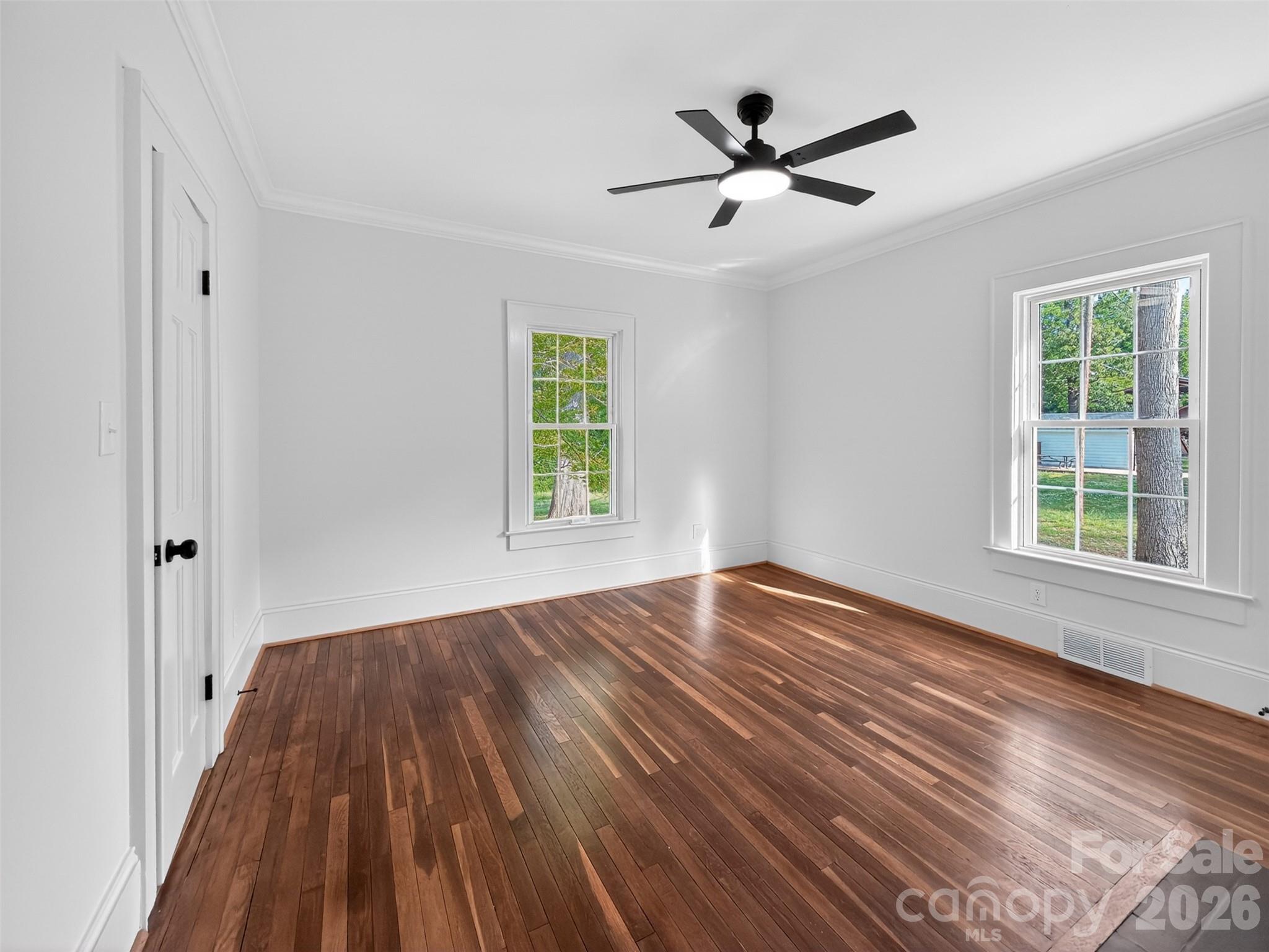 262 Pleasant Street Spindale, NC 28160 - Photo 16 of 37 wooden floor in an empty room with a window