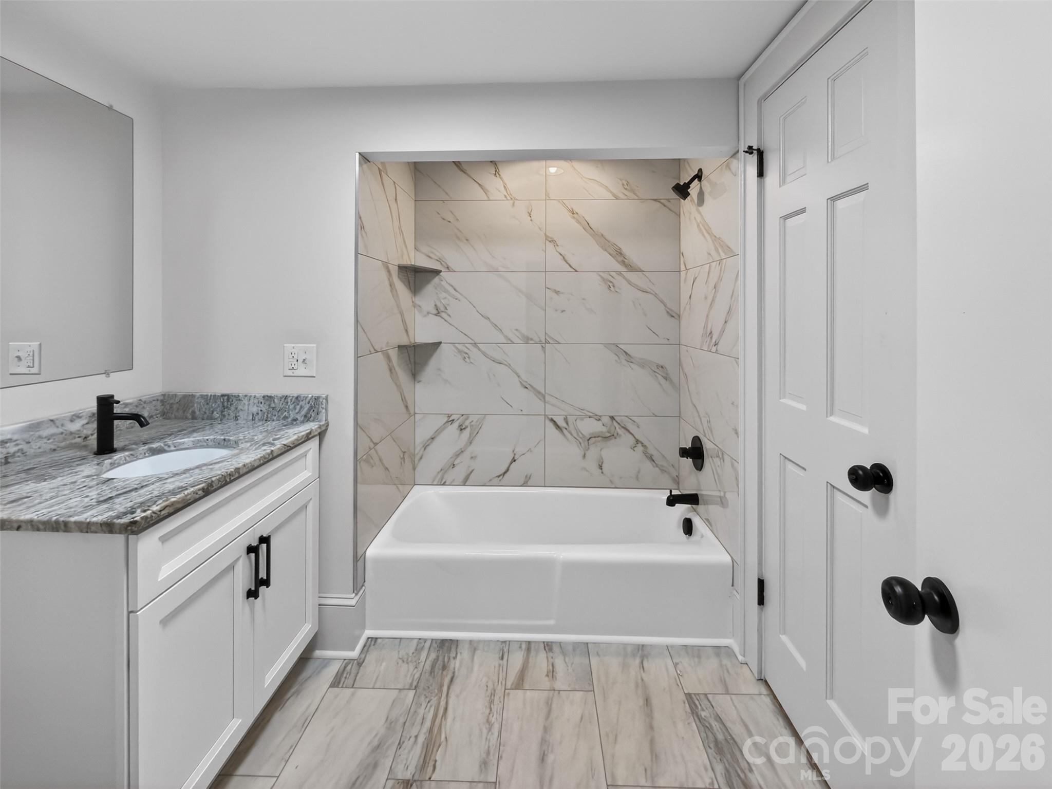 262 Pleasant Street Spindale, NC 28160 - Photo 17 of 37 a bathroom with a granite countertop sink a toilet and shower